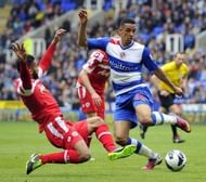 Reading striker Nick Blackman (R) vies with QPR's Armand Traore during their match in Reading on April 28, 2013